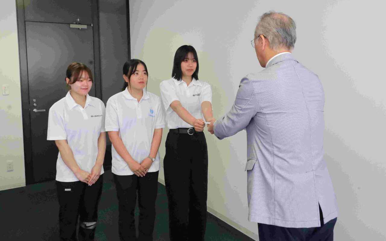 KCAA副会長の藤本淳也教授から目録を受け取る【大阪体育大学】